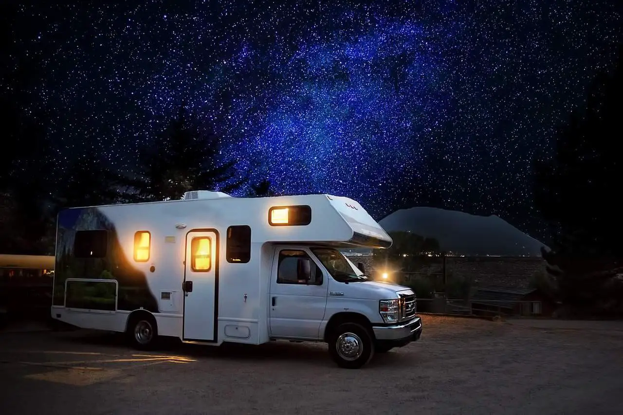 rv with blue night sky under the stars - rv air conditioner