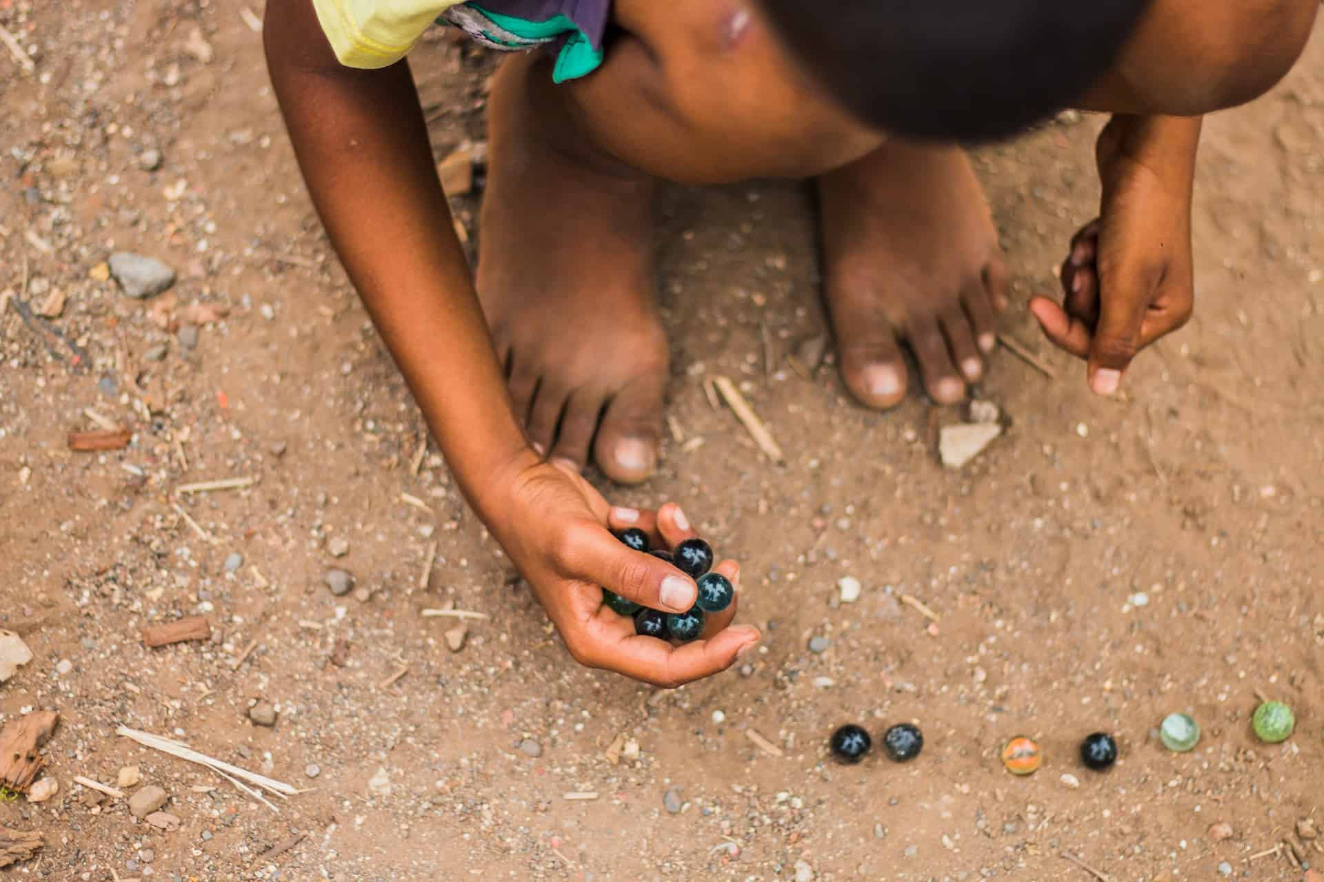 Kid playing marbles 